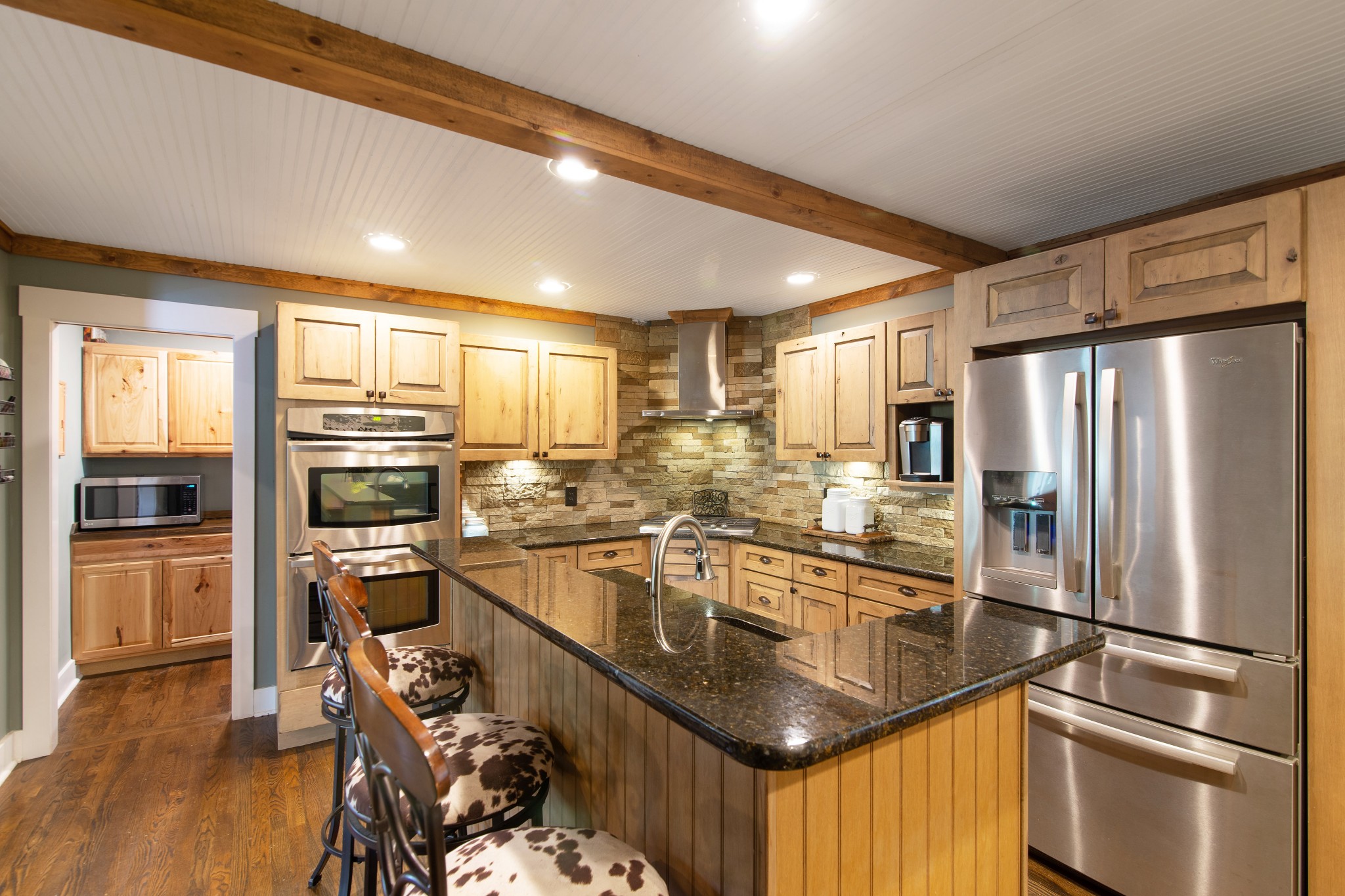 6249 Ladd Road Franklin, TN 37067 - Photo 11 of 50 a kitchen with stainless steel appliances granite countertop a refrigerator a stove and a sink with wooden floor