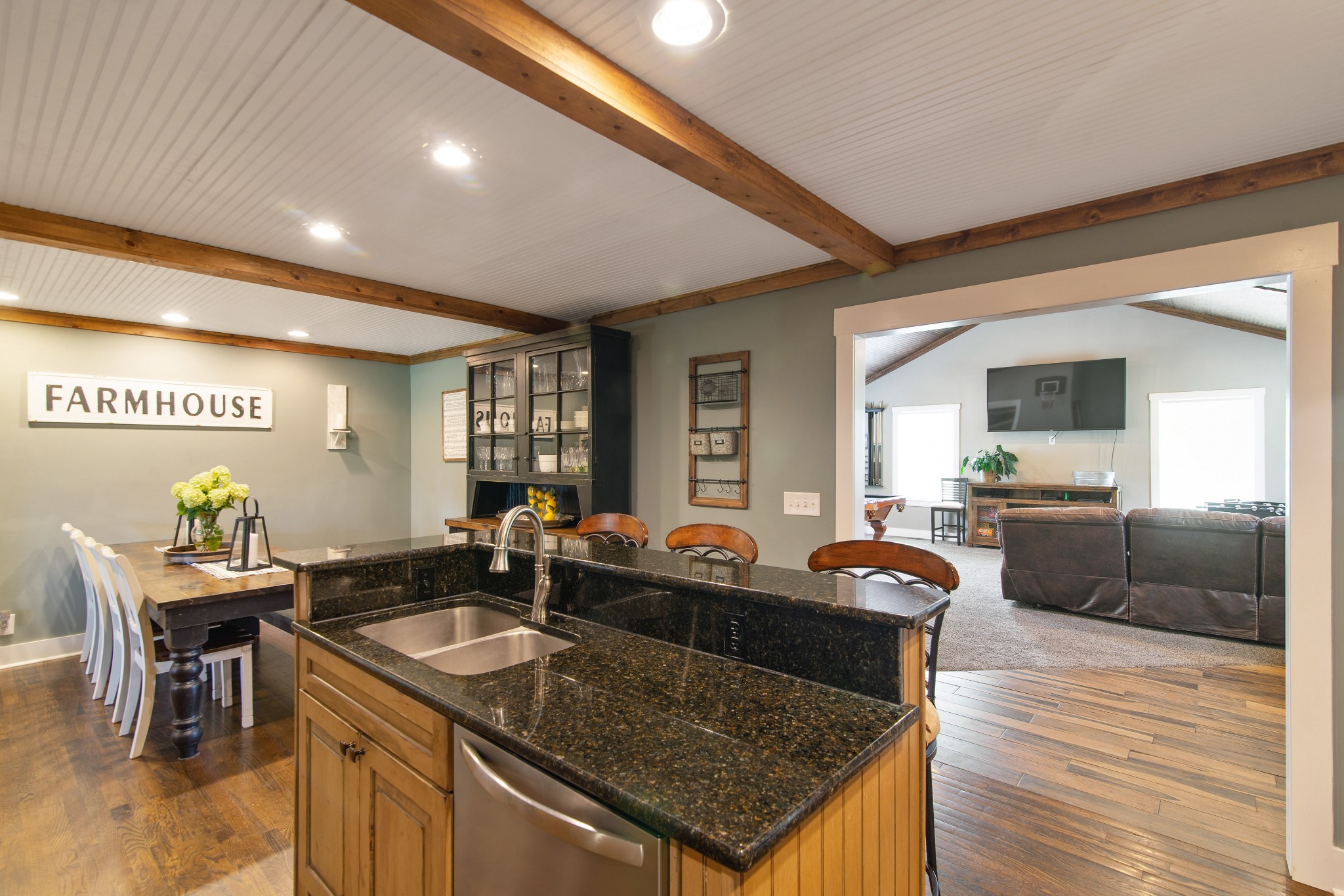 6249 Ladd Road Franklin, TN 37067 - Photo 13 of 50 a kitchen with a stove a sink a dining table and chairs with wooden floor
