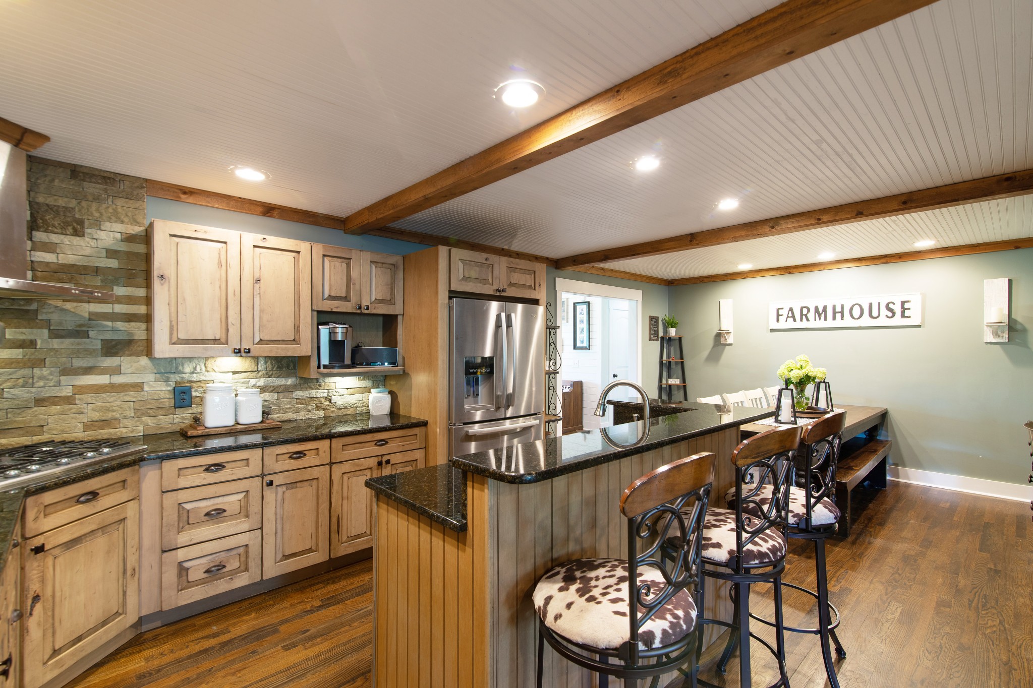 6249 Ladd Road Franklin, TN 37067 - Photo 14 of 50 a kitchen with stainless steel appliances kitchen island granite countertop a stove a sink a dining table and chairs