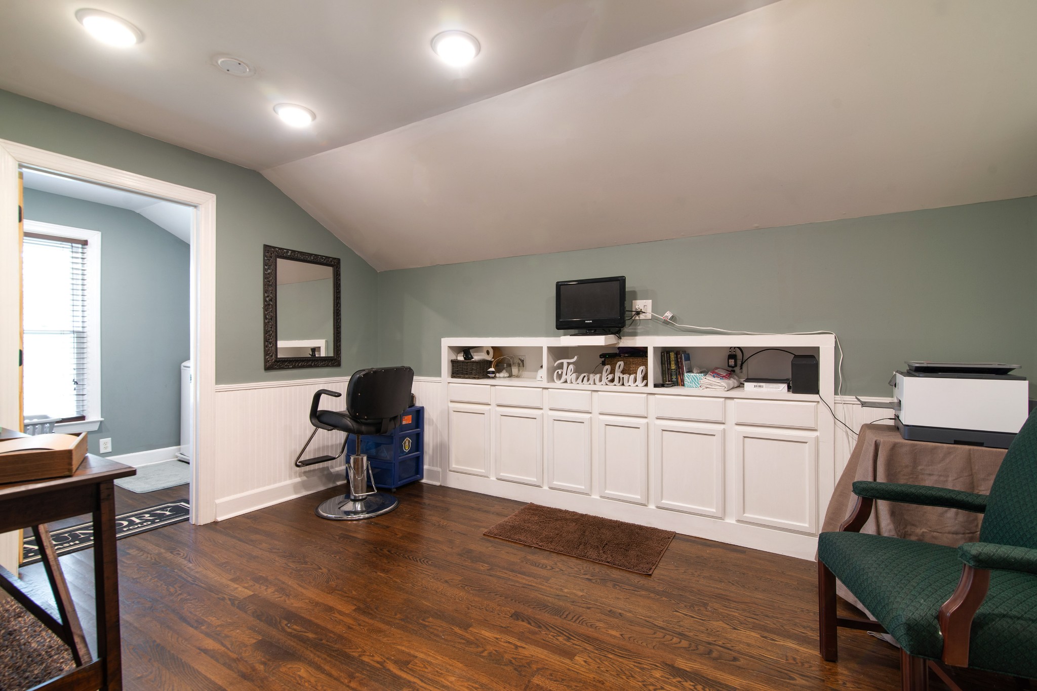 6249 Ladd Road Franklin, TN 37067 - Photo 24 of 50 a kitchen with a chair and white cabinets with wooden floor