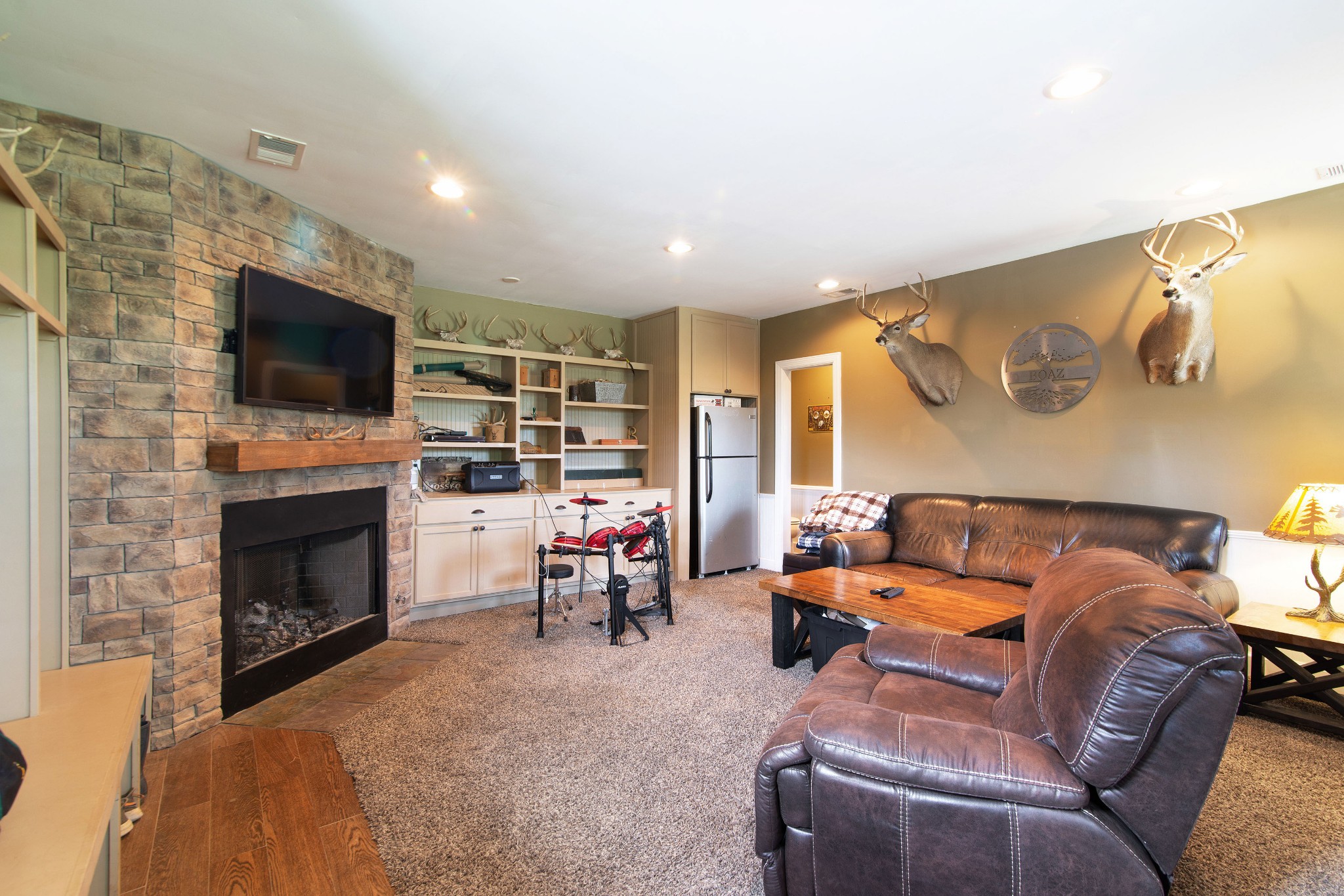 6249 Ladd Road Franklin, TN 37067 - Photo 36 of 50 a living room with furniture a fireplace and a flat screen tv