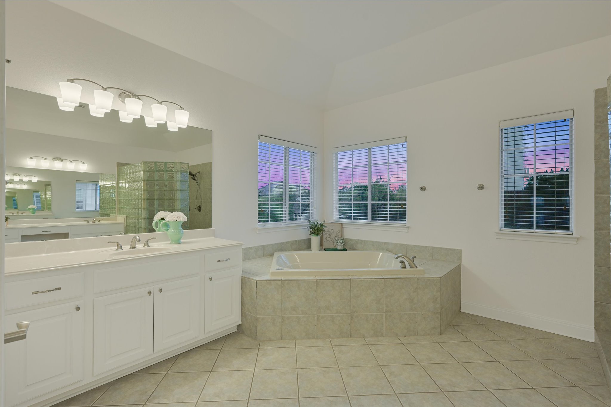 4319 Rum Runner Road Austin, TX 78734 - Photo 21 of 40 Bathroom featuring a stall shower, vanity, light tile patterned floors, and a garden tub