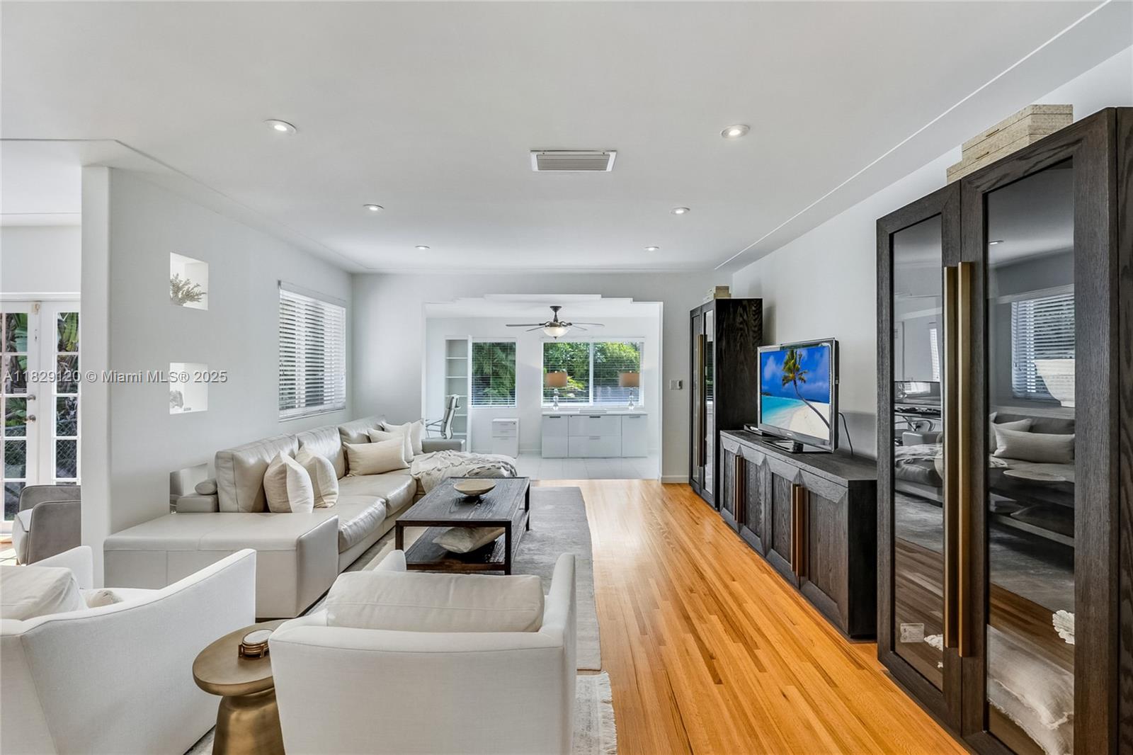 8811 Hawthorne Avenue Surfside, FL 33154 - Photo 11 of 47 a living room with furniture and a flat screen tv
