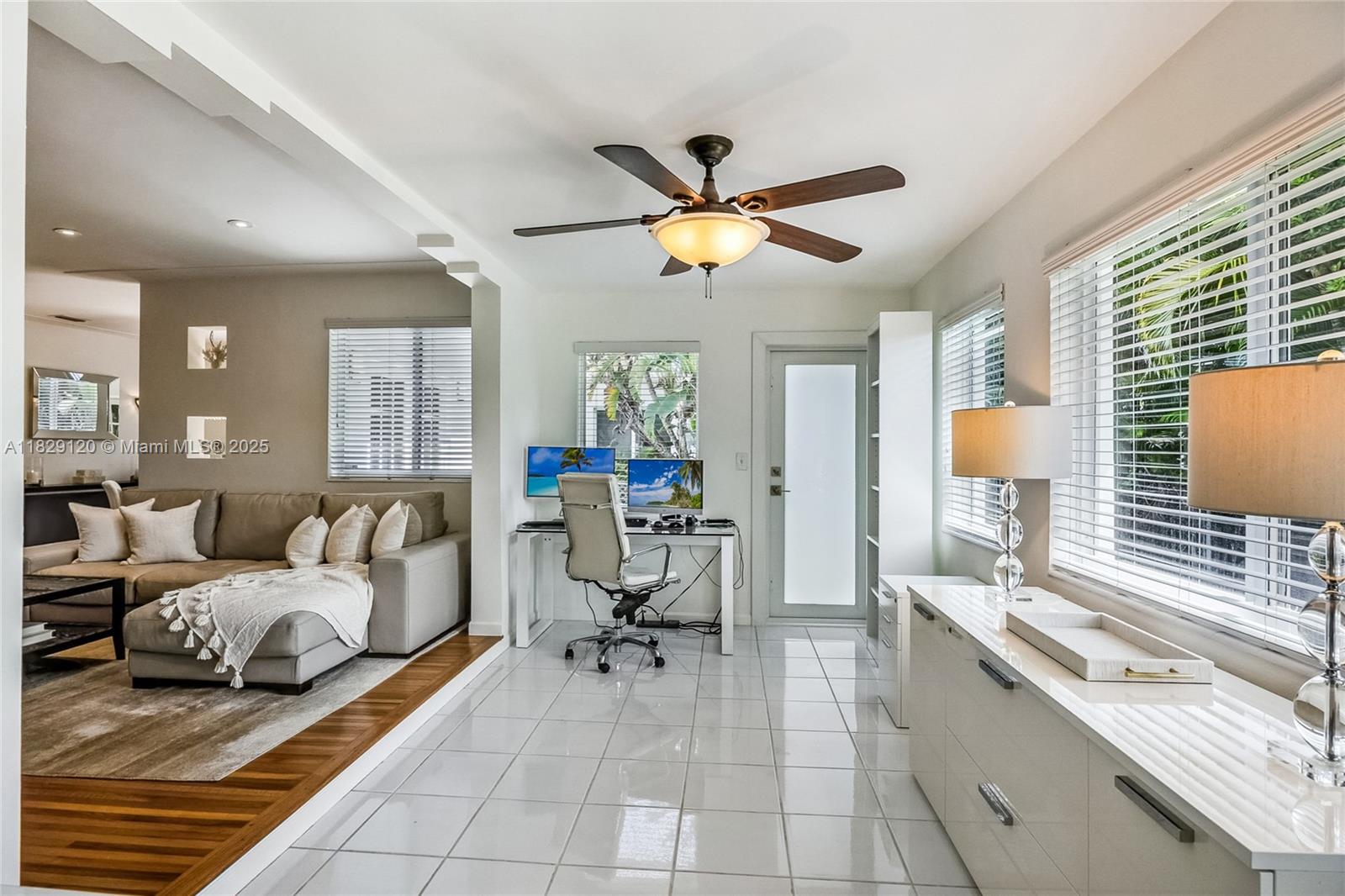 8811 Hawthorne Avenue Surfside, FL 33154 - Photo 15 of 47 a living room with furniture and a chandelier