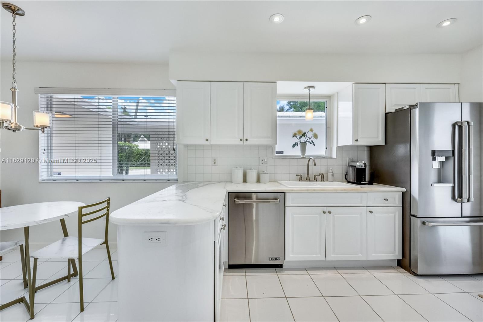 8811 Hawthorne Avenue Surfside, FL 33154 - Photo 17 of 47 a kitchen with a sink appliances and cabinets