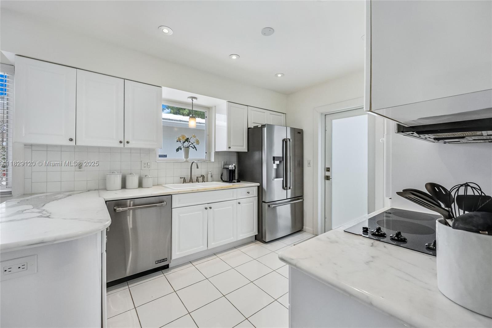 8811 Hawthorne Avenue Surfside, FL 33154 - Photo 18 of 47 a kitchen with stainless steel appliances a sink stove and refrigerator