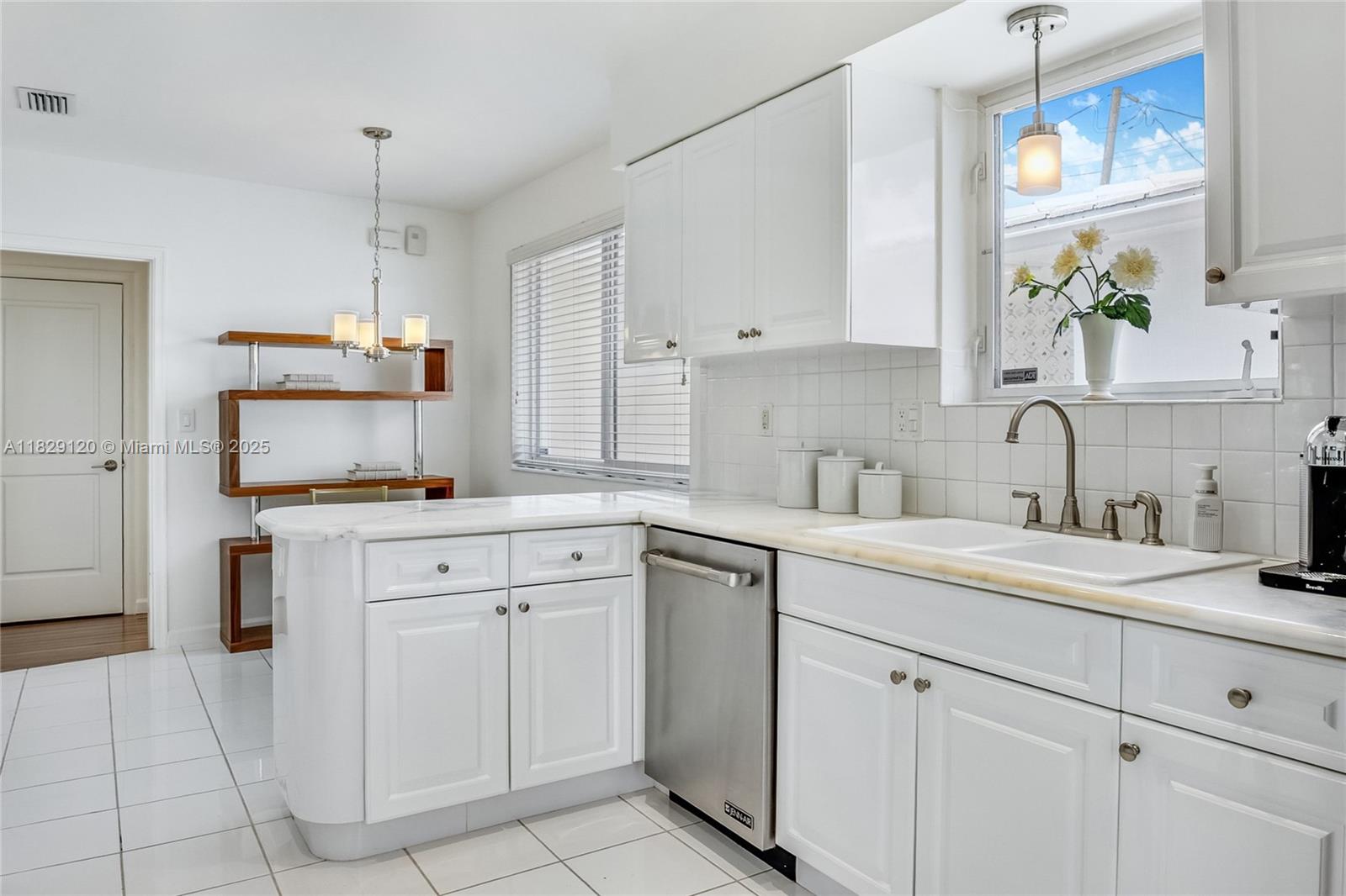 8811 Hawthorne Avenue Surfside, FL 33154 - Photo 20 of 47 a kitchen with white cabinets and white appliances