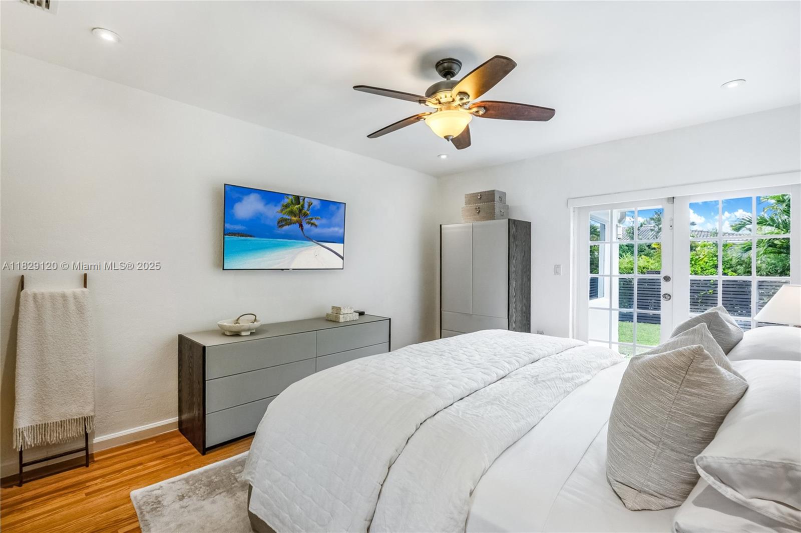 8811 Hawthorne Avenue Surfside, FL 33154 - Photo 28 of 47 a bedroom with a bed and a chandelier