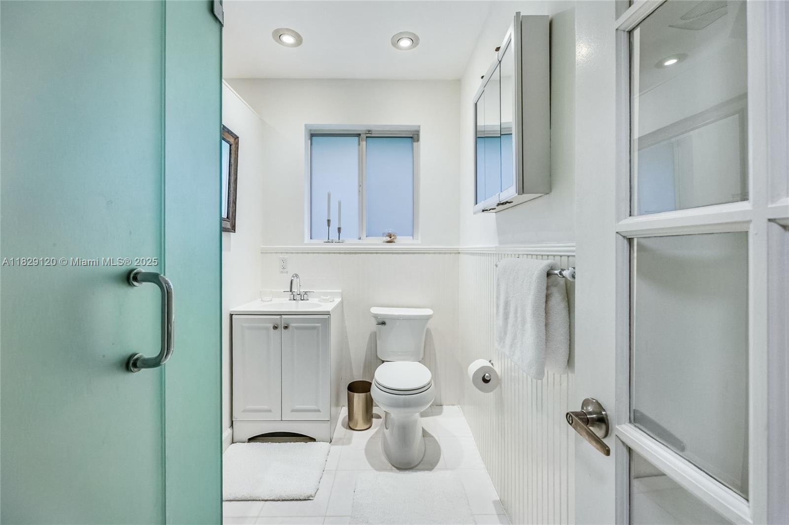 8811 Hawthorne Avenue Surfside, FL 33154 - Photo 33 of 47 a bathroom with a toilet sink and mirror