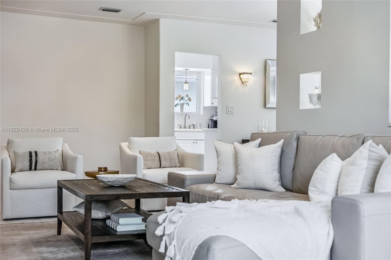 8811 Hawthorne Avenue Surfside, FL 33154 - Photo 35 of 47 a living room with furniture and a table