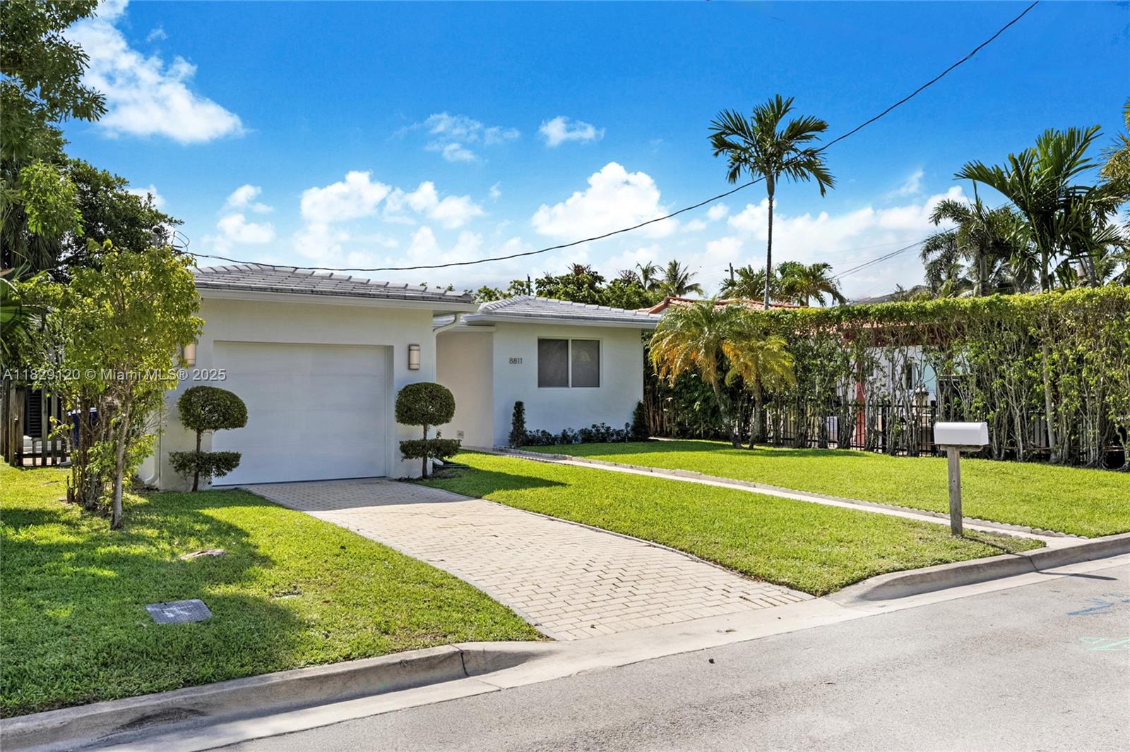 8811 Hawthorne Avenue Surfside, FL 33154 - Photo 40 of 47 a house view with swimming pool in front of it