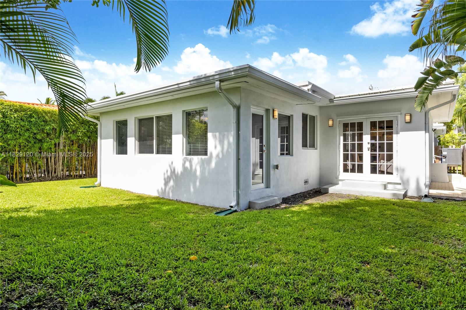 8811 Hawthorne Avenue Surfside, FL 33154 - Photo 42 of 47 a view of a house with a yard and porch