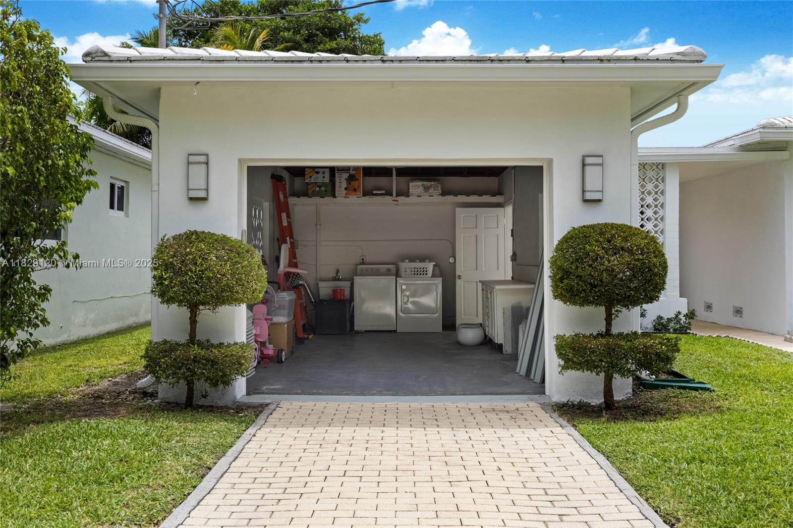 8811 Hawthorne Avenue Surfside, FL 33154 - Photo 43 of 47 a front view of a house with garden
