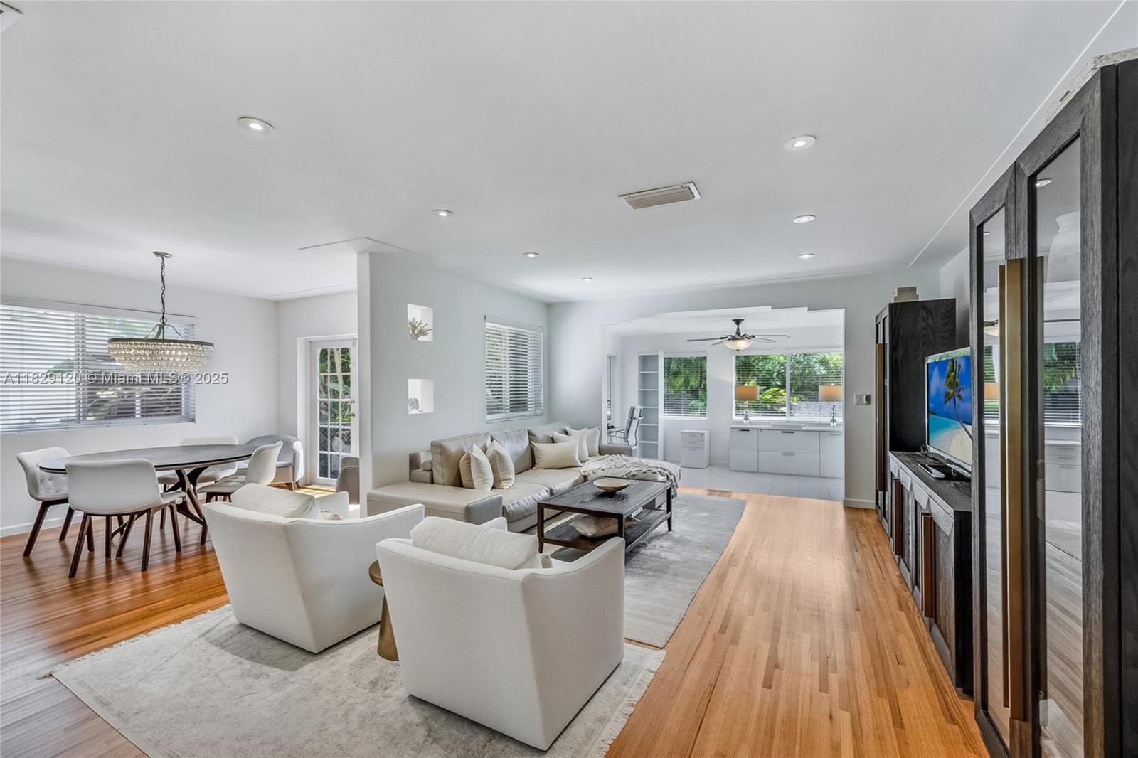 8811 Hawthorne Avenue Surfside, FL 33154 - Photo 8 of 47 a living room with furniture a wooden floor and a fireplace
