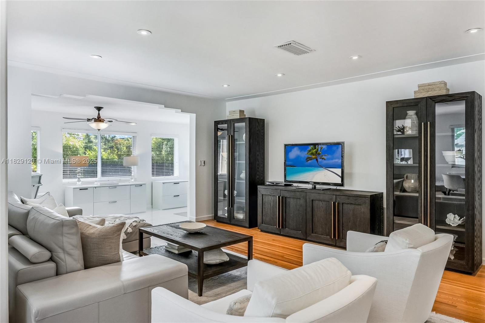 8811 Hawthorne Avenue Surfside, FL 33154 - Photo 9 of 47 a living room with furniture and a flat screen tv