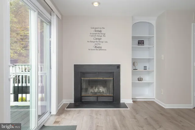 a living room with a fireplace and a window