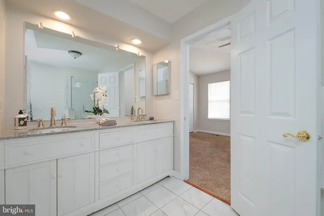a bathroom with a double vanity sink and a mirror