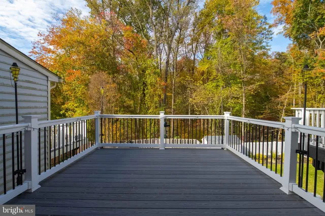 a view of balcony with wooden floor and fence