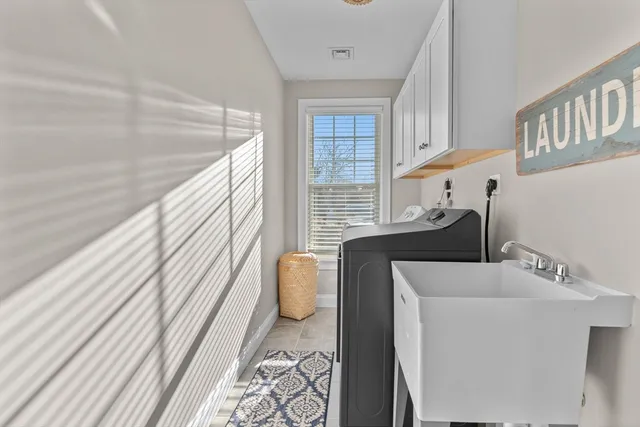 a front view of a house with swimming pool and sitting area