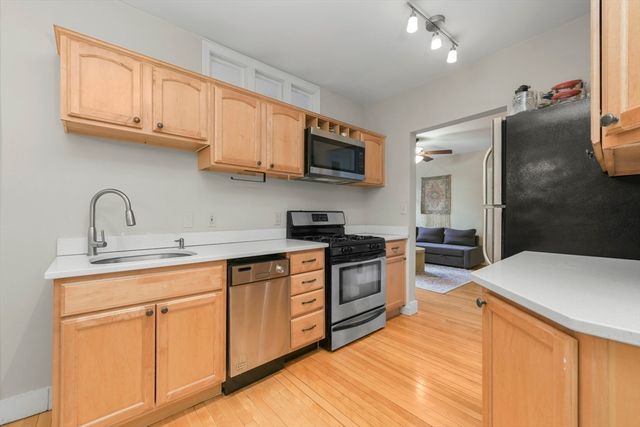a kitchen with stainless steel appliances granite countertop a sink and cabinets