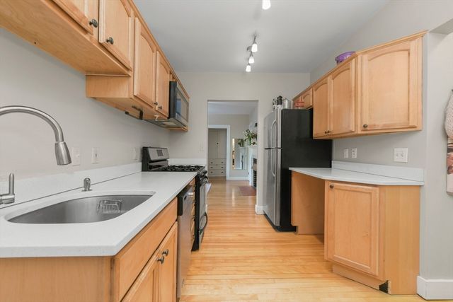 a kitchen with stainless steel appliances granite countertop a sink and cabinets