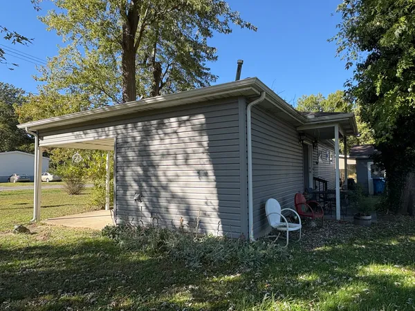 a backyard of a house with table and chairs