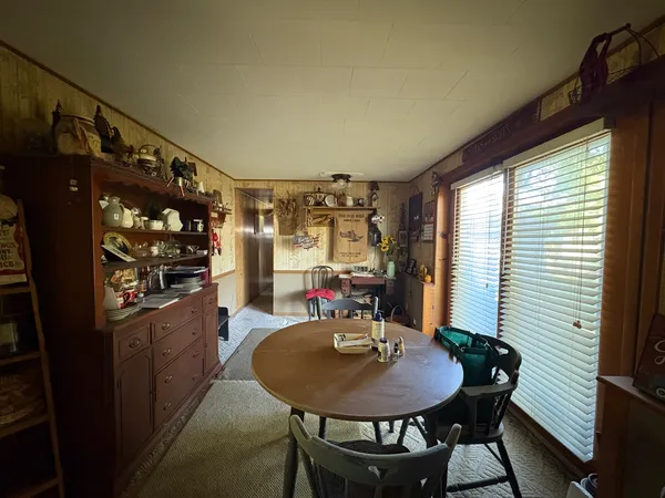 a view of a dining room with furniture and window