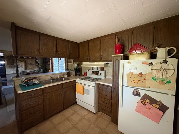 a kitchen with a sink a stove and cabinets