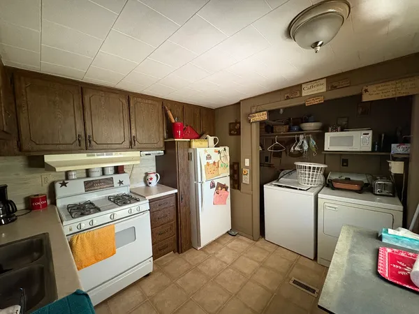 a kitchen with stainless steel appliances granite countertop a stove a refrigerator and a cabinets