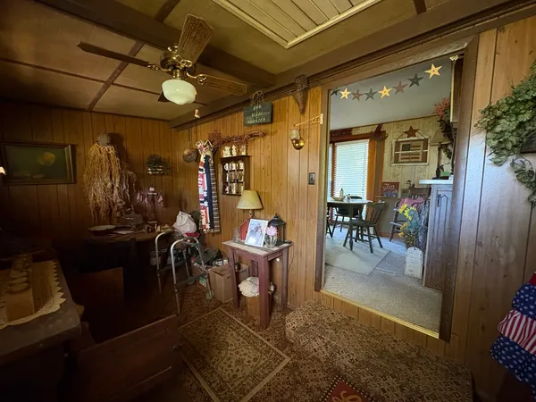 a living room with lots of furniture and kitchen view