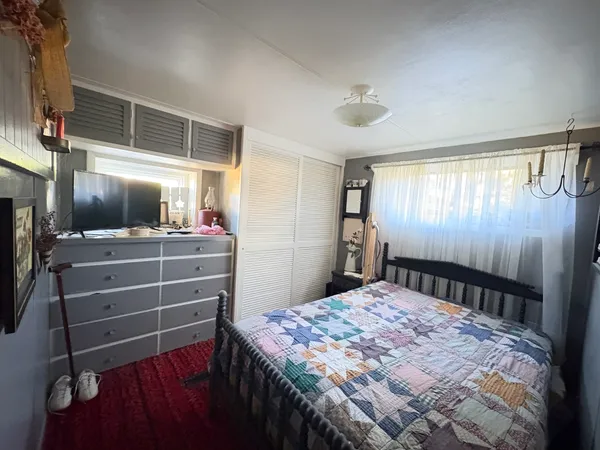 a bedroom with a bed and a ceiling fan