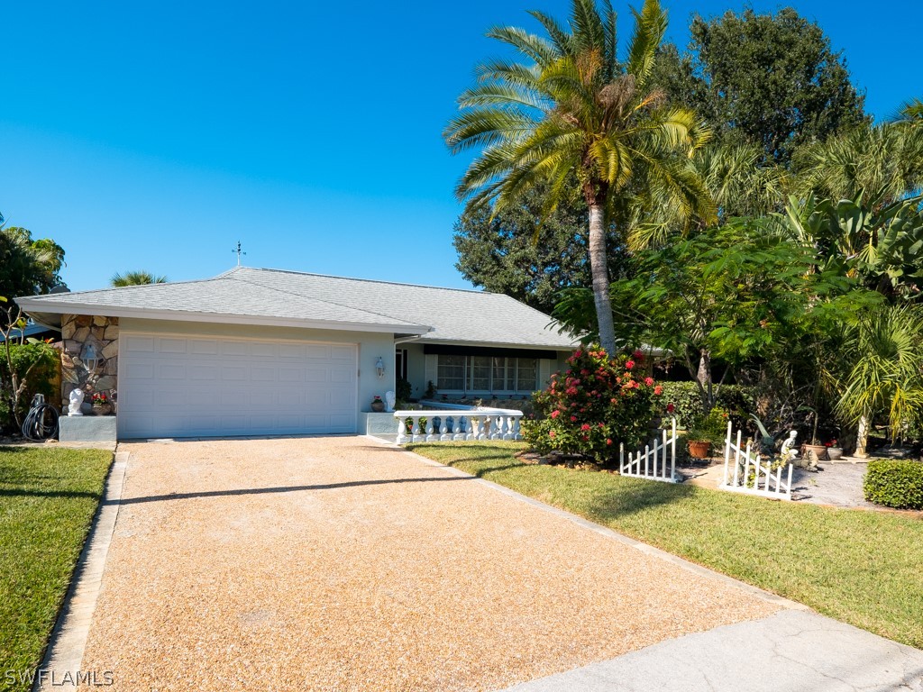 671 Rabbit Road Sanibel, FL 33957 - Photo 2 of 50 a house with palm tree in front of it