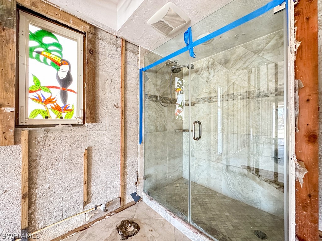 671 Rabbit Road Sanibel, FL 33957 - Photo 31 of 50 a bathroom with a shower and a sink a mirror