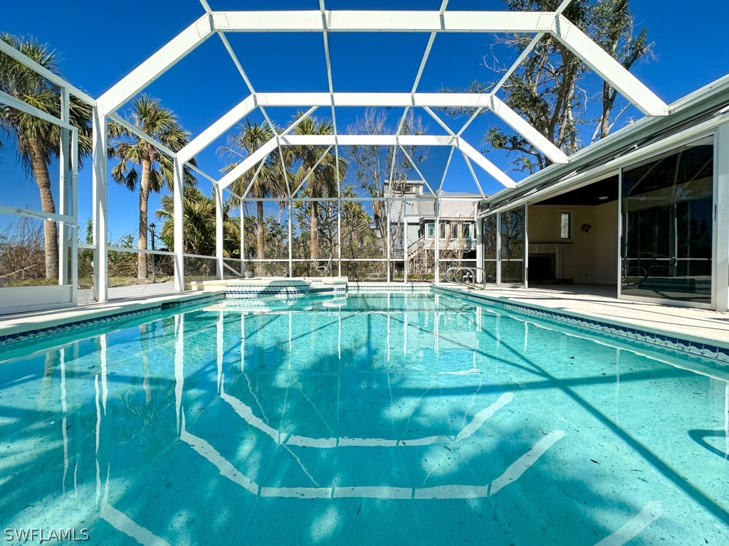 671 Rabbit Road Sanibel, FL 33957 - Photo 39 of 50 a view of a house with a swimming pool