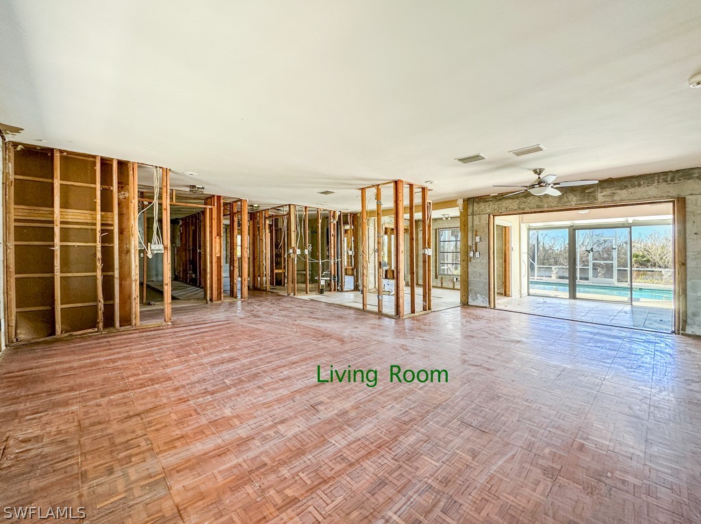 671 Rabbit Road Sanibel, FL 33957 - Photo 9 of 50 an empty room with windows and wooden floor