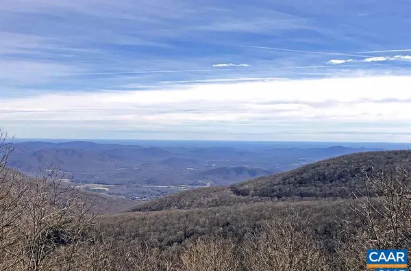 a view of an ocean beach and mountain
