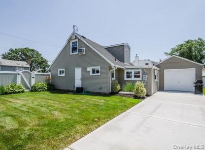 2 Fairfield Road Massapequa, NY 11758 - Photo 12 of 13 a front view of a house with a yard and garage