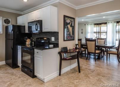 2 Fairfield Road Massapequa, NY 11758 - Photo 4 of 13 a kitchen with stainless steel appliances granite countertop a stove a refrigerator a dining table and chairs