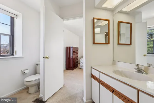 a en suite bathroom with a sink a toilet and a mirror