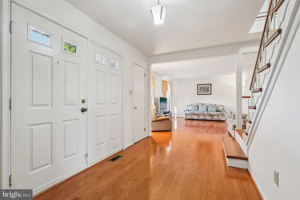 a view of a livingroom with wooden floor and furniture