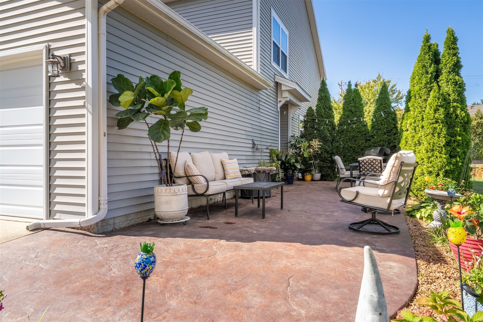 1661 Belclare Road Normal, IL 61761 - Photo 21 of 22 a view of a backyard with chair and potted plants