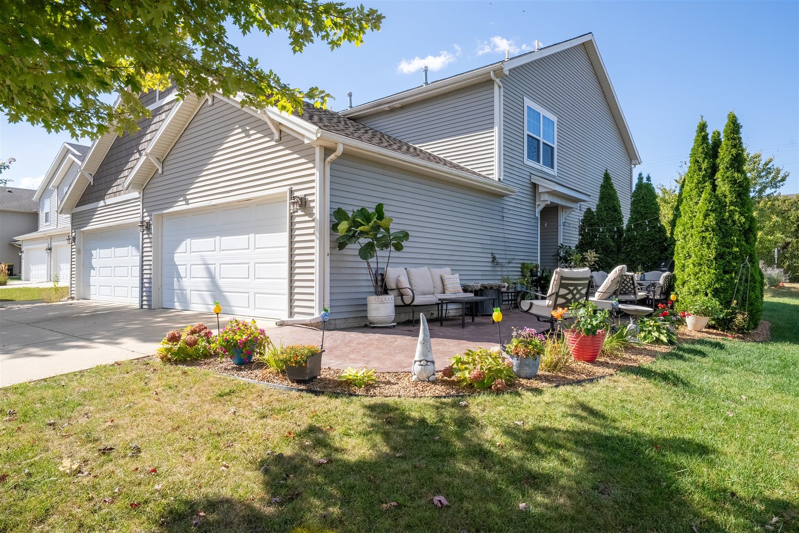 1661 Belclare Road Normal, IL 61761 - Photo 22 of 22 a view of backyard with a table and chairs and potted plants
