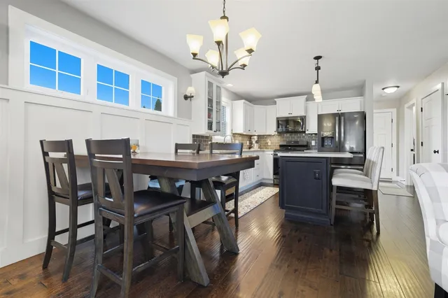 a view of a dining room with furniture wooden floor and chandelier