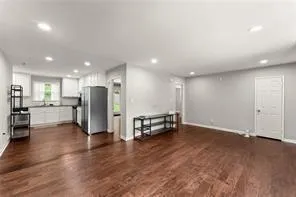 an empty room with wooden floor and furniture