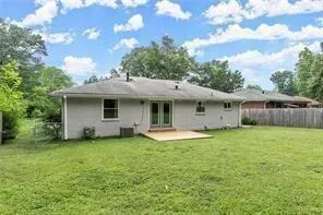 a view of a house with a yard and sitting area