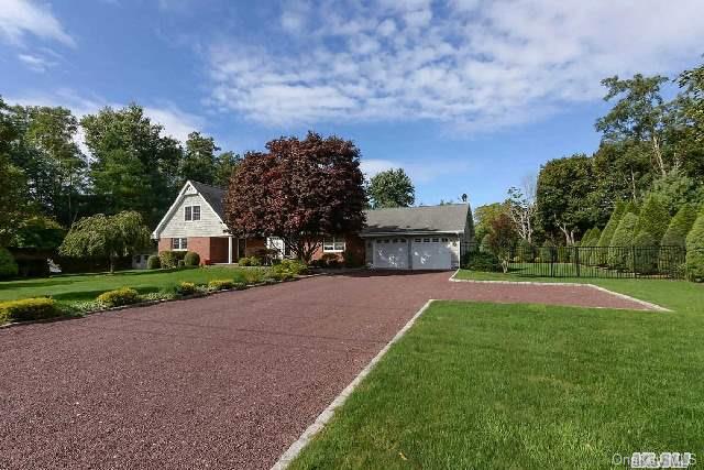 13 Felix Avenue Remsenburg, NY 11960 - Photo 1 of 1 a front view of a house with a yard and garage