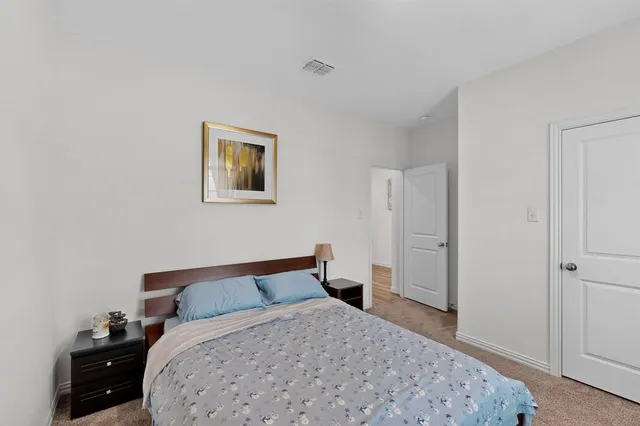 a bedroom with a bed and a dresser