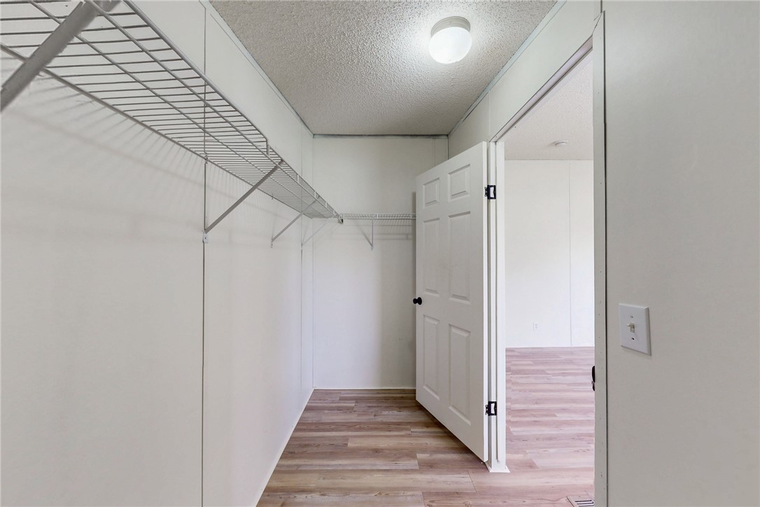 11459 Winstead Lane Calvert, TX 77837 - Photo 20 of 37 a view of a hallway with wooden floor and staircase