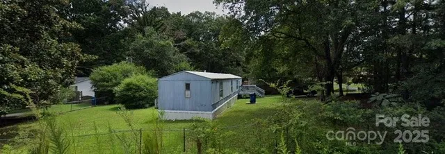 a view of a garden with large trees