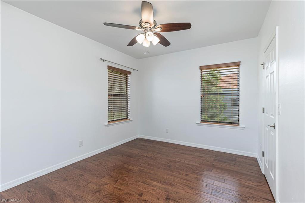 15326 Summit Pl Circle Naples, FL 34119 - Photo 12 of 21 wooden floor in an empty room with a window